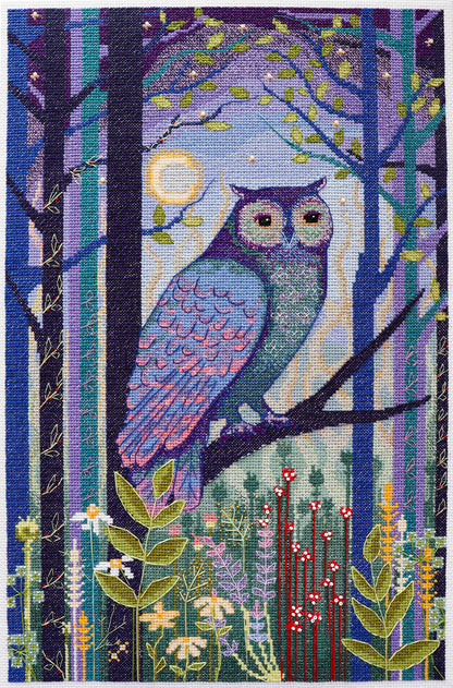 Embroidered design of an owl in a forest with trees and flowers.